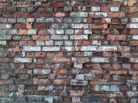 A wall with a torn brick of old age for use as a background or screen saver.の写真素材