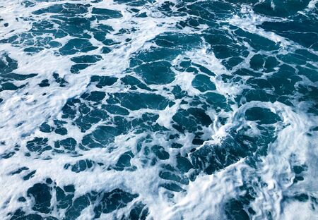 Restless movement of foam waves. Background of water in the sea.の写真素材