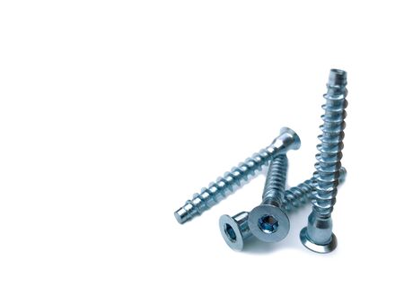 Element coupler for connecting parts in the manufacture of furniture and other products. Screws on a white background, four pieces.の写真素材