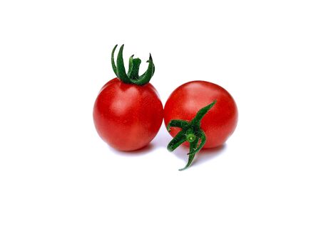 Fresh cherry tomatoes on a white background with a sunny shadow. Summer plant. Food product.の写真素材