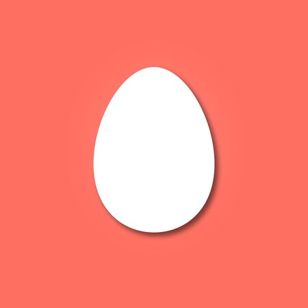 Flat shape of a white bird egg with shadow on a coral background. Minimal layout for Easter greeting cards.の写真素材