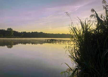 Early dawn on the lake. Morning steam.の写真素材