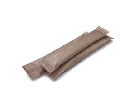 Paper brown sticks for sugar, salt, coffee and spices on a white background with a sunny shadow. Eco packaging for bulk products.の写真素材