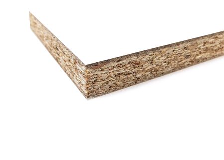 Wood chips and sawdust pressed into sheet material. On a white background with place for text. Uni color board. For the manufacture of cabinet furniture.の写真素材