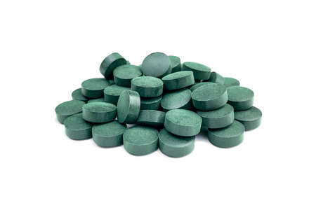 Spirulina algae tablets on a white background.の写真素材