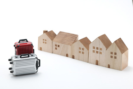 Houses and suitcases on white background. Vacation rentals, renting private homes and rooms.の写真素材