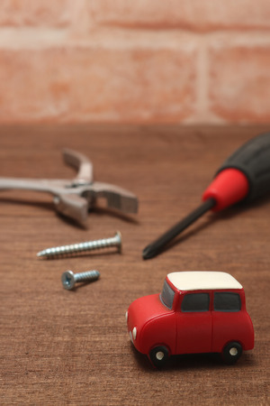 Miniature car and maintenance tools on wood. Concept of car maintenance.の写真素材