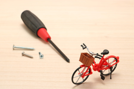 Miniature bicycle and maintenance tools on wood. Concept of bicycle maintenance.の写真素材
