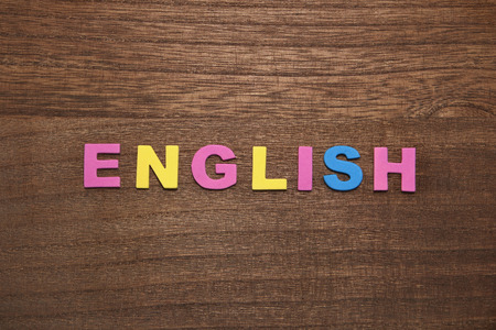 On wood ENGLISH alphabet letters. English education concept.の写真素材