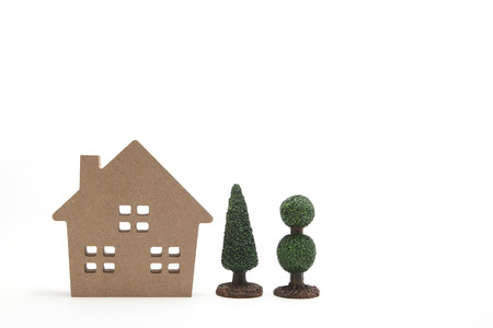 Miniature house and trees on white background. New house concept.の写真素材