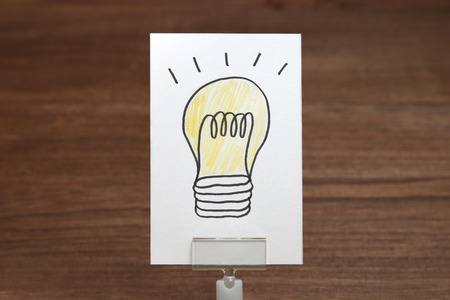 Light bulb drawn on white paper. The solution concept.の写真素材