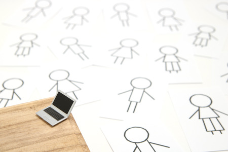 Network service concept (SNS). People on paper and miniature laptop.の写真素材