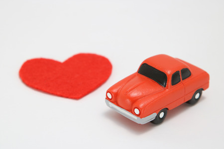 Red heart and car on white background. Safe driving concept.の写真素材