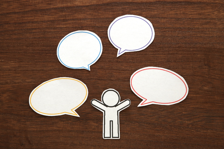 Paper person with colorful blank dialog speech bubbles. Communication concept.の写真素材