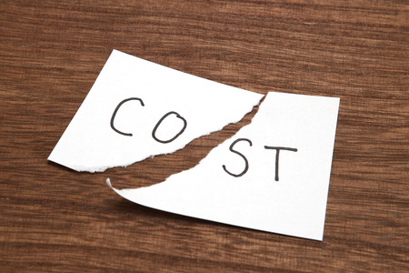 Cut the word cost concept for recession or credit crisis on wood.の写真素材