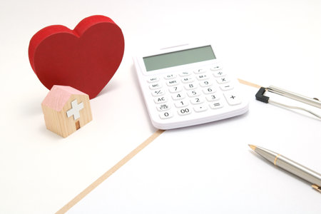 Medical Expenses and Healthcare Concept | Calculator and Hospital Miniatureの写真素材