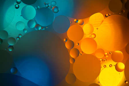 Beautiful color abstract background based on blue, turquoise and yellow circles, macro abstraction. Mixing water and oilの写真素材