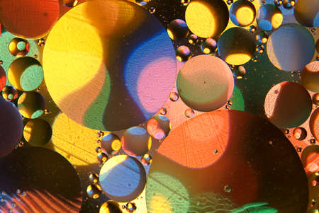 Abstract colorful backdrop with oil drops on water surfaceの写真素材
