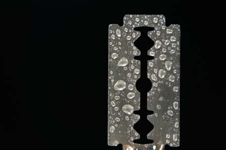 Traditional razor blade with water droplets on black background. Macro shootingの写真素材