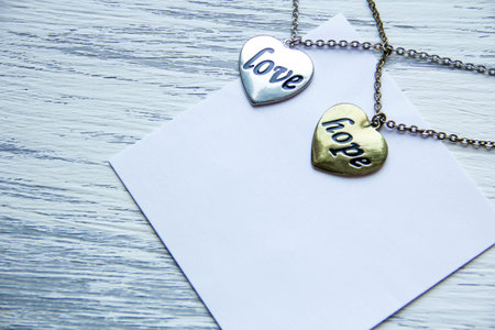 pendant in the shape of a heart hope and love