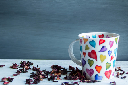 Love concept, cup of red tea, heart shape  on wooden floor.の写真素材
