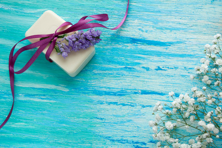 mockup natural organic soap with flowers on a blue wooden tableの写真素材