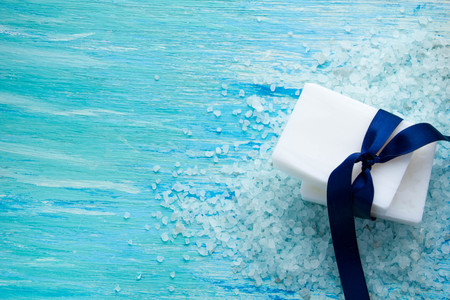 natural organic soap, and sea salt on a blue wooden tableの写真素材