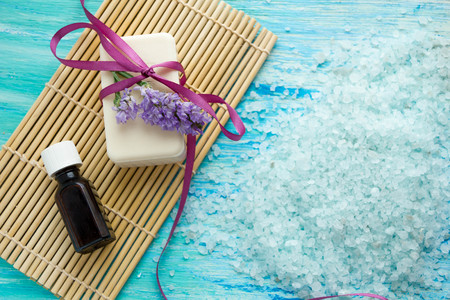 natural organic soap bottles essential oil and sea salt on a blue wooden table, Spa withの写真素材