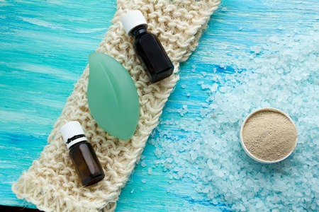 natural organic soap bottles essential oil and sea salt herbal bath  on a blue wooden table, Spaの写真素材
