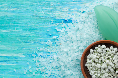 natural organic soap, and sea salt with flowers on a blue wooden table spaの写真素材