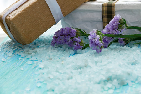 sea salt  on a blue wooden table, Spa with flowersの写真素材