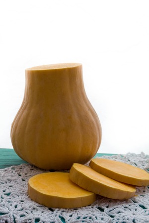fresh pumpkin cut into pieces on wooden background, food, recipesの写真素材