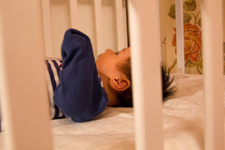 Sleeping at night the newborn boy lay in the crib. Top viewの写真素材