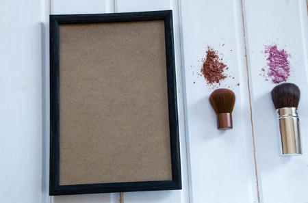 women's accessories cosmetics. Makeup brushes and crushed eyeshadow on woodenの写真素材