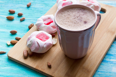 offee morning concept. Sweet pastel colored marshmallow and cup of coffee on aquamarine backgroundの写真素材
