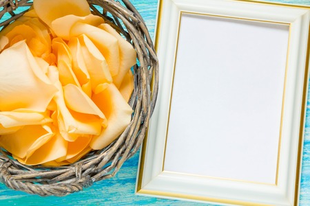 flowers rose petals on turquoise wooden background, notebook, mockup, place for text,の写真素材