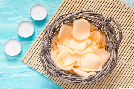 flowers rose petals on turquoise wooden background, notebook, mockup, place for text,の写真素材