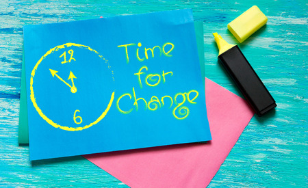 time for change white-painted clock inspirational quotes lettering for postcards, business ideas, announcements,  note with beautiful handwriting of a female hand notebook. wooden backgroundの写真素材