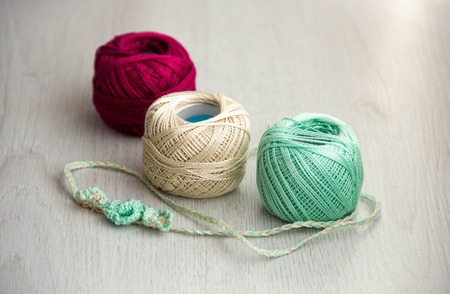 Crochet hooks and balls of yarn on wooden background with copy space Basket with hue knitting yarns hobby  handmade, tailor, hand sewing and knitting theme design.の写真素材