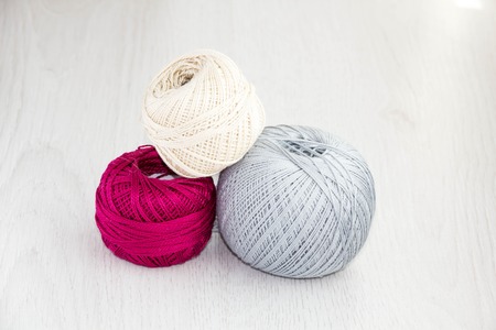 Crochet hooks and balls of yarn on wooden background with copy space Basket with hue knitting yarns hobby  handmade, tailor, hand sewing and knitting theme design.の写真素材