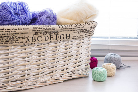 Crochet hooks and balls of yarn on wooden background with copy space Basket with hue knitting yarns hobby  handmade, tailor, hand sewing and knitting theme design.の写真素材