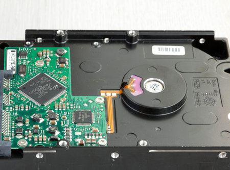 Person holding a hard drive for a computer, on wooden background