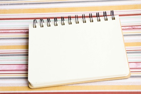 Open notebook on desk, on wooden table, can be used for your text or artwork, Top view business conceptの写真素材