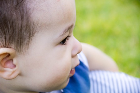 close the face of the little toddler boy with a sly expression, which is going be naughty.の写真素材