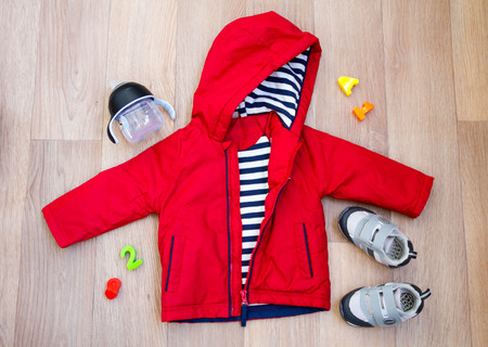 baby winter clothing, concept, autumn, sneakers, caps, toys. how to dress baby winter. choose the shoes.の写真素材