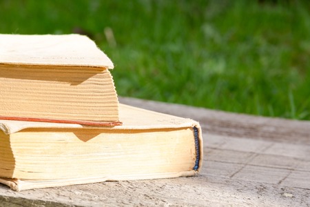 Old hardcover books selective focus. Education concept on wooden background. to learn foreign languages. the remote training. Back to school background with copy space for text ads. exam preparationの写真素材