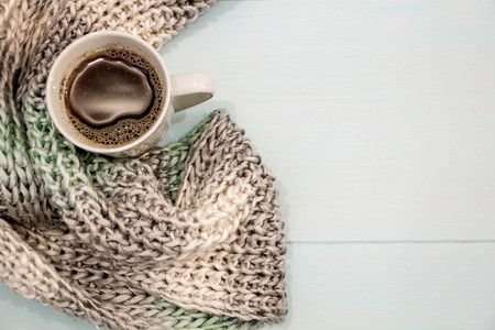 Cosy soft winter background, knitted sweater Cup hot coffee old vintage wooden board. Christmas holidays at home. place for text, Top view flat lay with copy space for slogan or text messageの写真素材