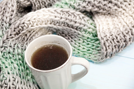 Cosy soft winter background, knitted sweater Cup hot coffee old vintage wooden board. Christmas holidays at home. place for text, Top view flat lay with copy space for slogan or text messageの写真素材