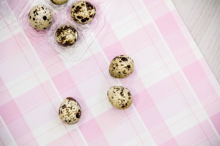 Plate with quail eggs. Quail eggs in a wooden bowl. place for text. nutrition protein diet. Top view, flat lay with copyspace for slogan or text message. colorful backgroundの写真素材