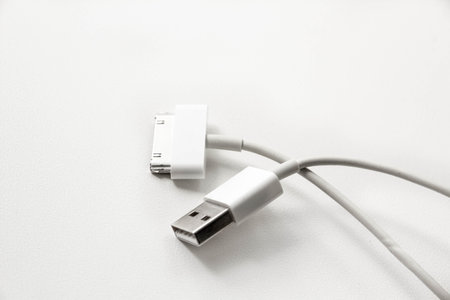 White wire usb mobile charging cable. 2 different cellphone charging plugs adapter from USB isolated...